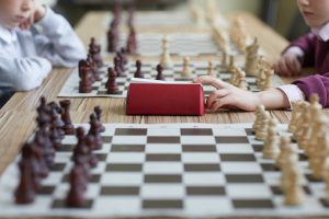 Girl pressing chess clock